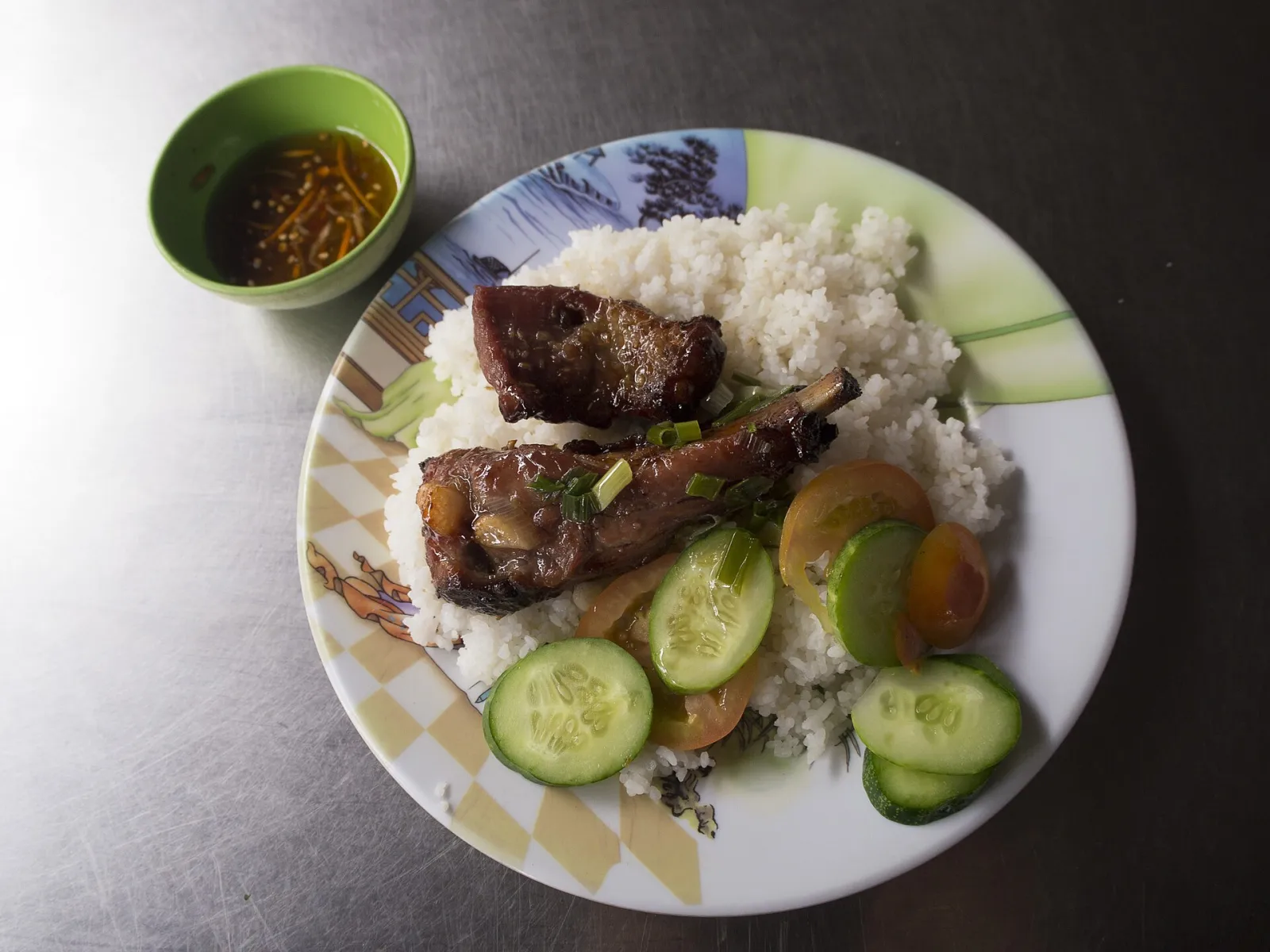 Com tam, il riso spezzato di Saigon Piatto di com tam, riso spezzato con costolette di maiale alla griglia, tipico street food di Saigon